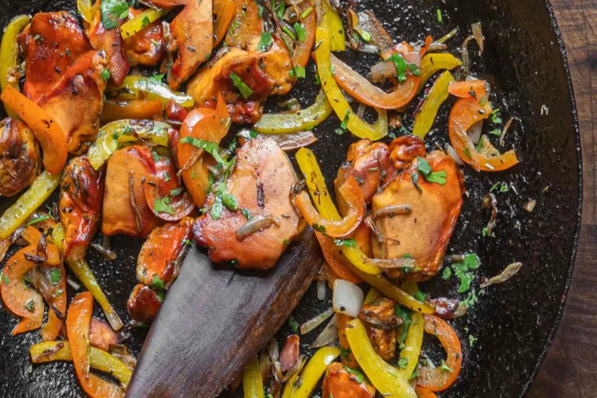 A skillet filled with golden-brown Chicken of the Woods mushrooms, garnished with fresh parsley.