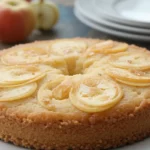 A slice of invisible apple cake on a white plate, dusted with powdered sugar.